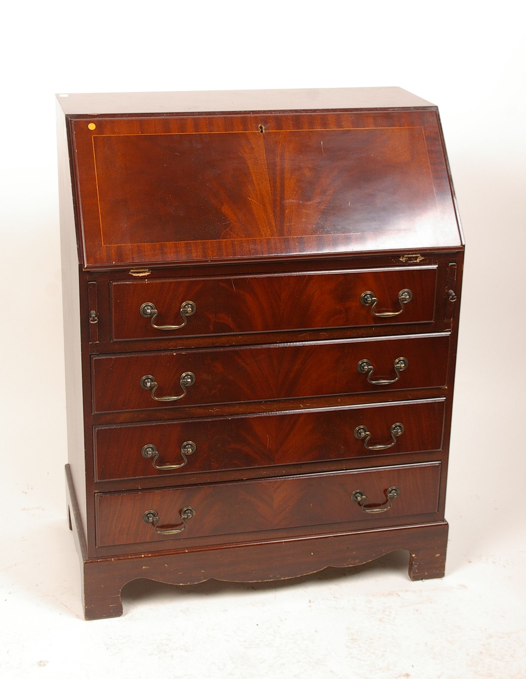 A George III style mahogany bureau with four graduated drawers on bracket feet 99cm high, 75cm wide