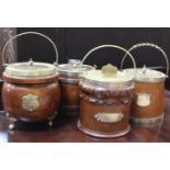 A collection of eight early 20th century oak biscuit barrels with silver plated mounts and ceramic