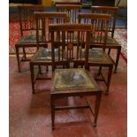 A set of six Edwardian mahogany and crossbanded dining chairs with leather drop in seats