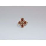 A 9ct gold and red garnet ring. Four oval garnets claw set in a quatrefoil design. 3.9g Size N