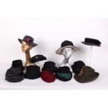 A collection of ladies hats, to include an early 20th Century black pleated crepe hat, a black straw