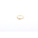 An 18k gold single stone diamond ring. central oval old cut diamond 4mm x 3mm, in a bezel setting