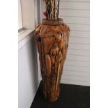 A large floor-standing driftwood vase