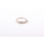 A five stone diamond ring. Claw set line of five round brilliant cut diamonds to an unmarked