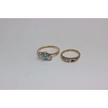 A 9ct gold ring set with round cut blue zircon in a claw setting with white zircon accents. Size Y