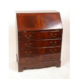 A George III style mahogany bureau with four graduated drawers on bracket feet 99cm high, 75cm