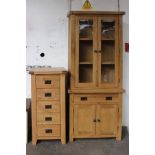 A light oak, glazed-top dresser (h: 200cm w: 85cm d: 35cm) and a five drawer chest (h: 110 w: 55cm