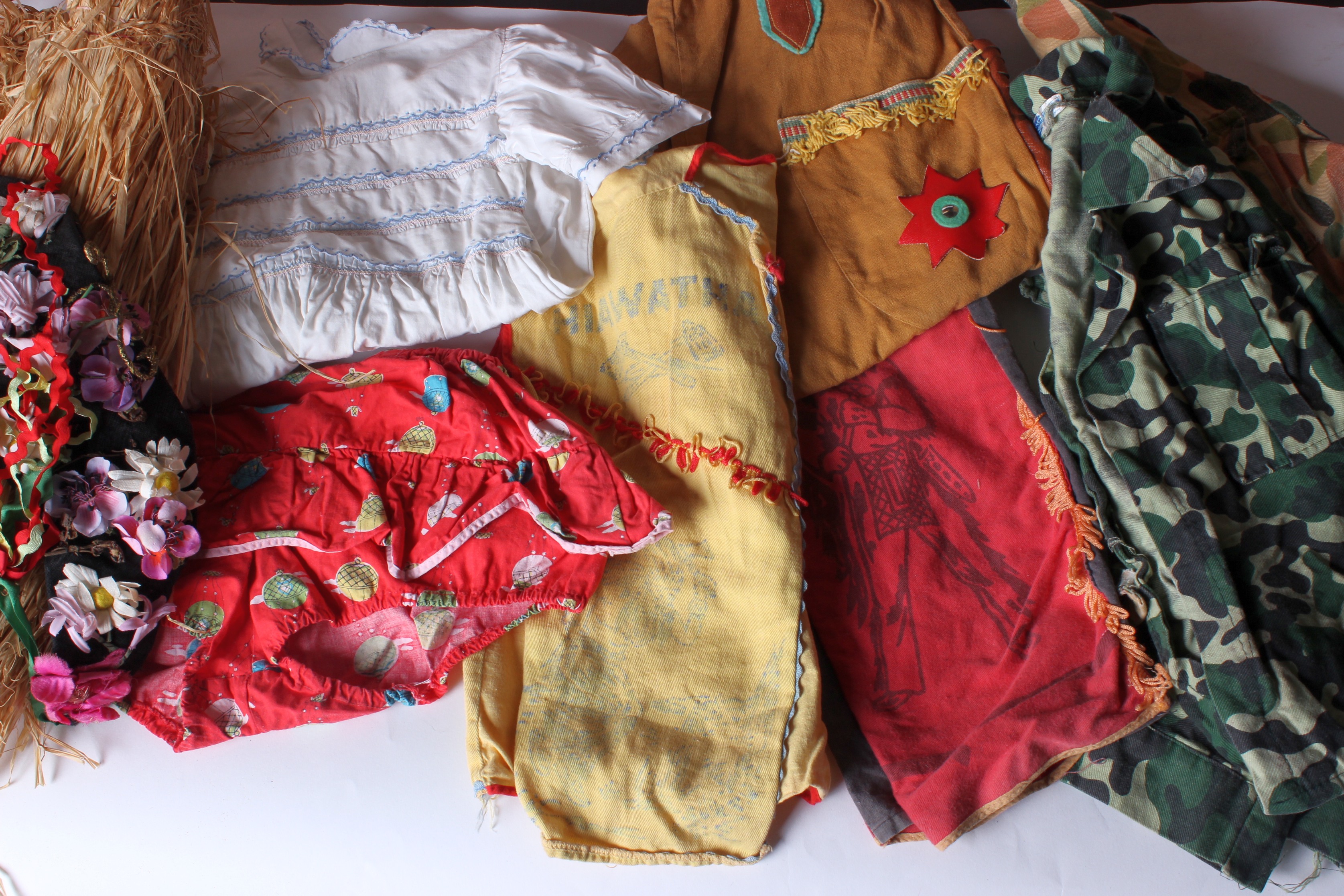 A quantity of childrens clothing from the 1950s to the 1970s; to include toddler smock dresses,