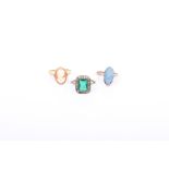 A 9ct rose gold opal ring set with marquise shaped opal doublet in a double four claw setting