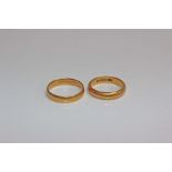 Two 22ct gold wedding bands 10.8g . Size R/N