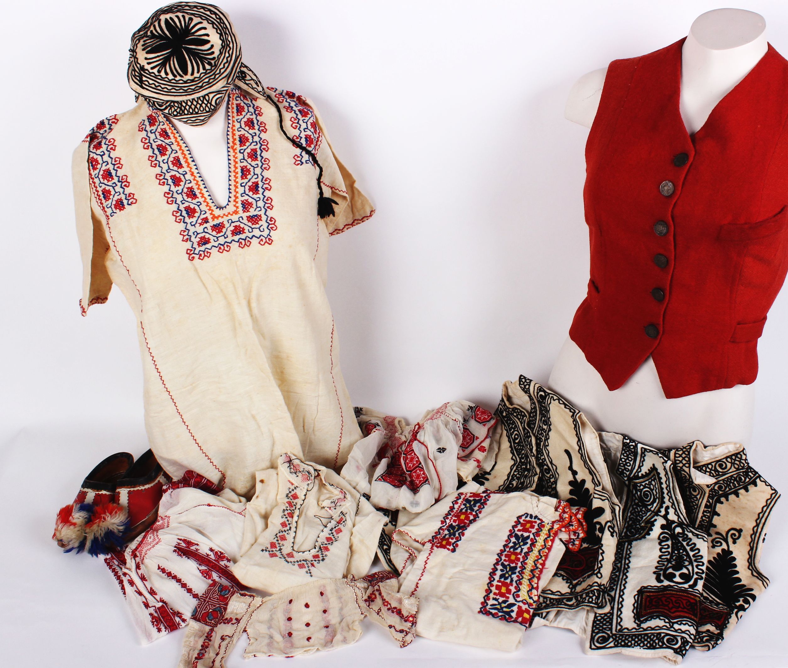 A red wool waistcoat with a checked lining and Bavarian coin buttons; three cream children's