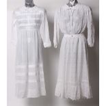 An early 20th Century white lawn cutwork long sleeved blouse; a white embroidered lawn skirt skirt