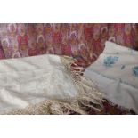 Three late 19th Century printed wool shawls; a Paisley patterned silk shawl, a fine wool cream