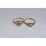 Two 18ct gold gem set rings. An 18ct gold ring set with central round cabochon cut moonstone in a