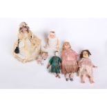 A collection of early to mid 20th Century dolls; including two ceramic doll heads with blue glass