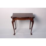 A mahogany card table on shell carved cabriole legs bearing 'Shaw of London' label 74cm high, 92cm