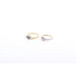 Two 18ct gold rings the first a diamond illusion set flower ring together with a three stone