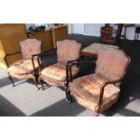 Three upholstered salon armchairs with button-back detail and pad feet.