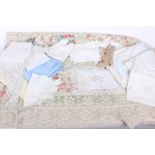 An early 20th Century floral patterned patchwork and crochet coverlet; a quantity of sewing items,