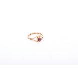 A 9k gold ruby ring. Central oval free cut ruby in a rubover setting. size P. 2.6 g