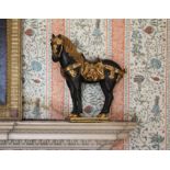 A pair of gilt decorated models of classical horses, 40cms wide (2)