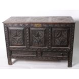 An Indian hardwood carved coffer with triple panelled front and drawers below 130cm wide