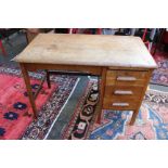 An oak knee hole desk. Three short drawers with reading slide.