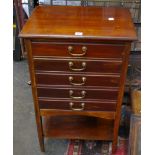 A mahogany music cabinet and Edwardian coal scuttle