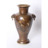 A Japanese style bronzed vase with lion mask ring handles 43cm high