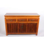 An Oriental hardwood side cabinet with three drawers and cupboards below 122cm length