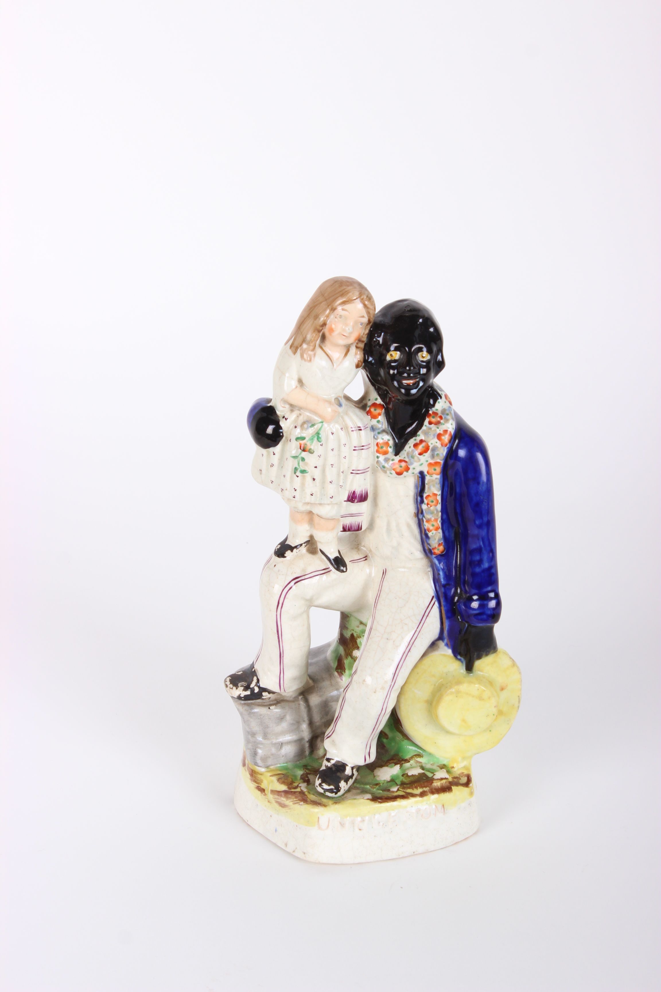 Victorian Staffordshire figure of Uncle Tom and Eva, decorated in under-glaze blue, black and