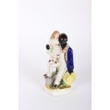 Victorian Staffordshire figure of Uncle Tom and Eva, decorated in under-glaze blue, black and