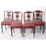 A set of four Edwardian rosewood chairs each with inlaid slat back, upholstered seat on turned legs