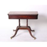 A Regency mahogany, line inlaid and crossbanded tea table on four column support, splayed legs and