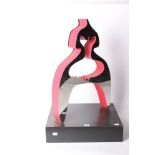 A modern mirrored and red-painted sculpture, of abstract form, standing on a black plinth, 62cm tall