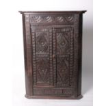 An Indian hardwood carved corner cabinet 97cm with an associated corner stand