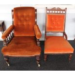 Two late Victorian/Edwardian button-back easy chairs with bobbin rail detail and porcelain castors.