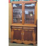 A Victorian oak two part glazed bookcase 220cm high, 127cm wide