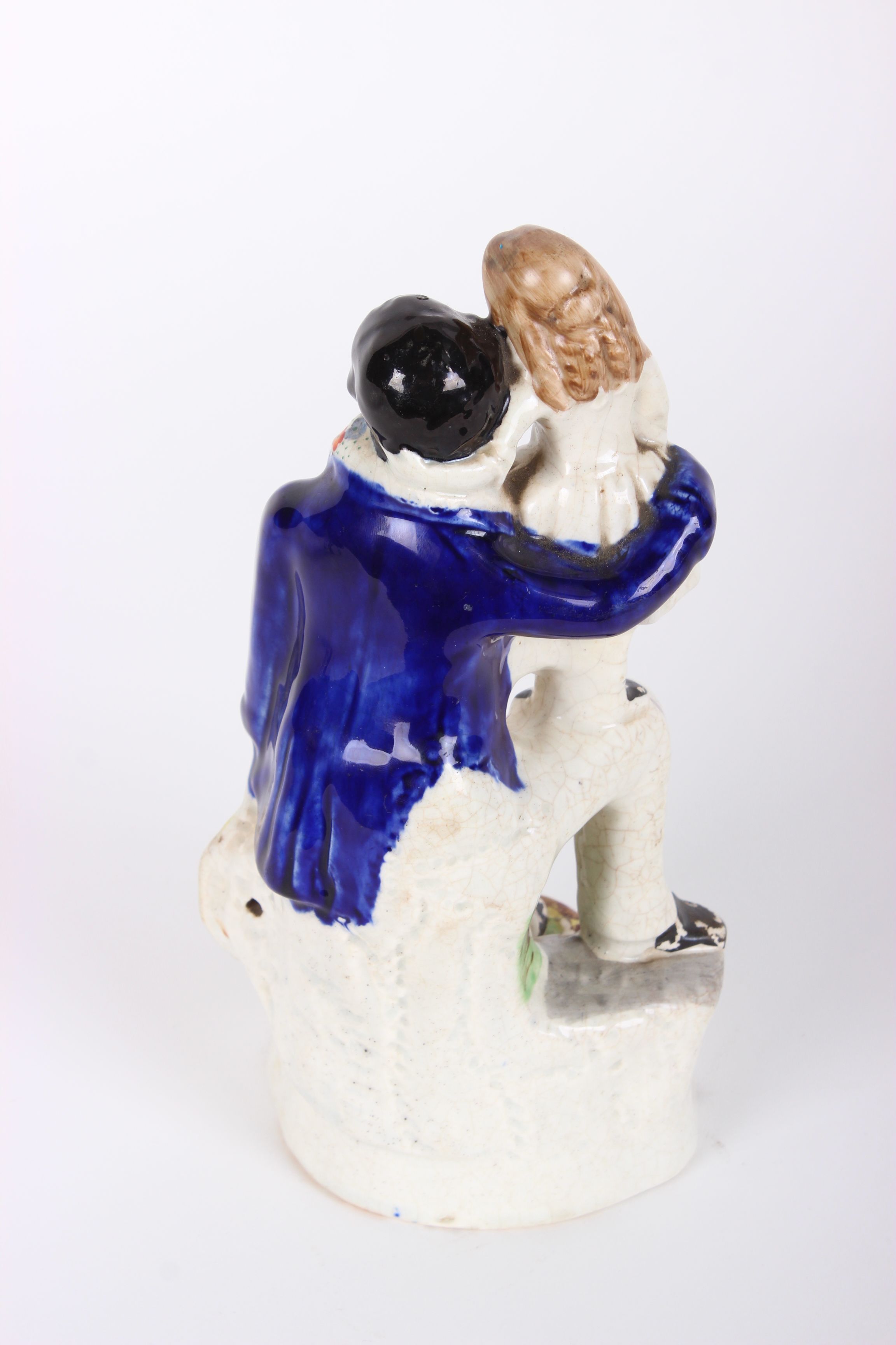 Victorian Staffordshire figure of Uncle Tom and Eva, decorated in under-glaze blue, black and - Image 2 of 3
