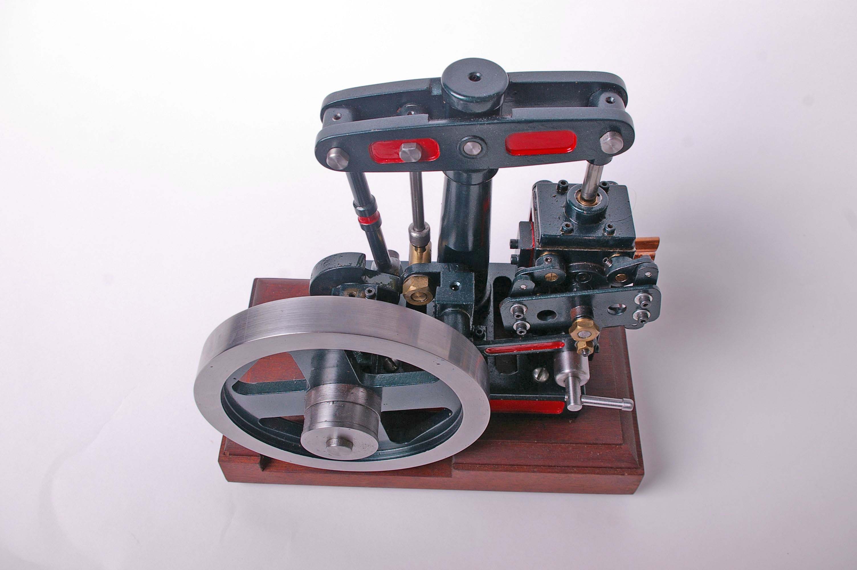 A model beam stationary engine in red and green livery on a mahogany plinth base. 25cm - Image 2 of 2