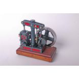 A model beam stationary engine in red and green livery on a mahogany plinth base. 25cm