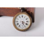 An early 20th century Oak Goliath pocket watch stand. with fitted Goliath pocket watch signed