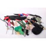 A collection of early 20th Century millinery feathers, many still with their original Paris, made in