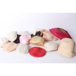 A quantity of millinery items, including hat moulds and shapes, lace visors, fine straw hat