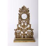 An ornate Victorian cast brass pocket watch stand, height 25cm with unmarked white metal pocket