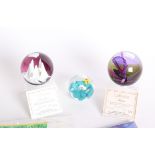 Three Caithness paperweights two with certificates 'Magenta' and 'Snowflame', H M Queen Elizabeth