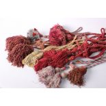 A collection of tassels and trimmings, comprising tie-backs, chenille tassels, macramé edging and