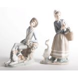 Two Lladro porcelain figures of Girl with geese 4568 24cm high and Boy with a dog 4659 (2)