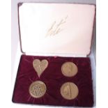 A set of 1980s four bronze medallions by Erte, Russian French marked 1892 and 1921 in filled case.