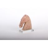 A model of a terracotta horse on stand 19cm high